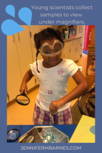 Image of a child scientist wearing goggles and clutching a magnifying glass focusing on inquiry based learning for science