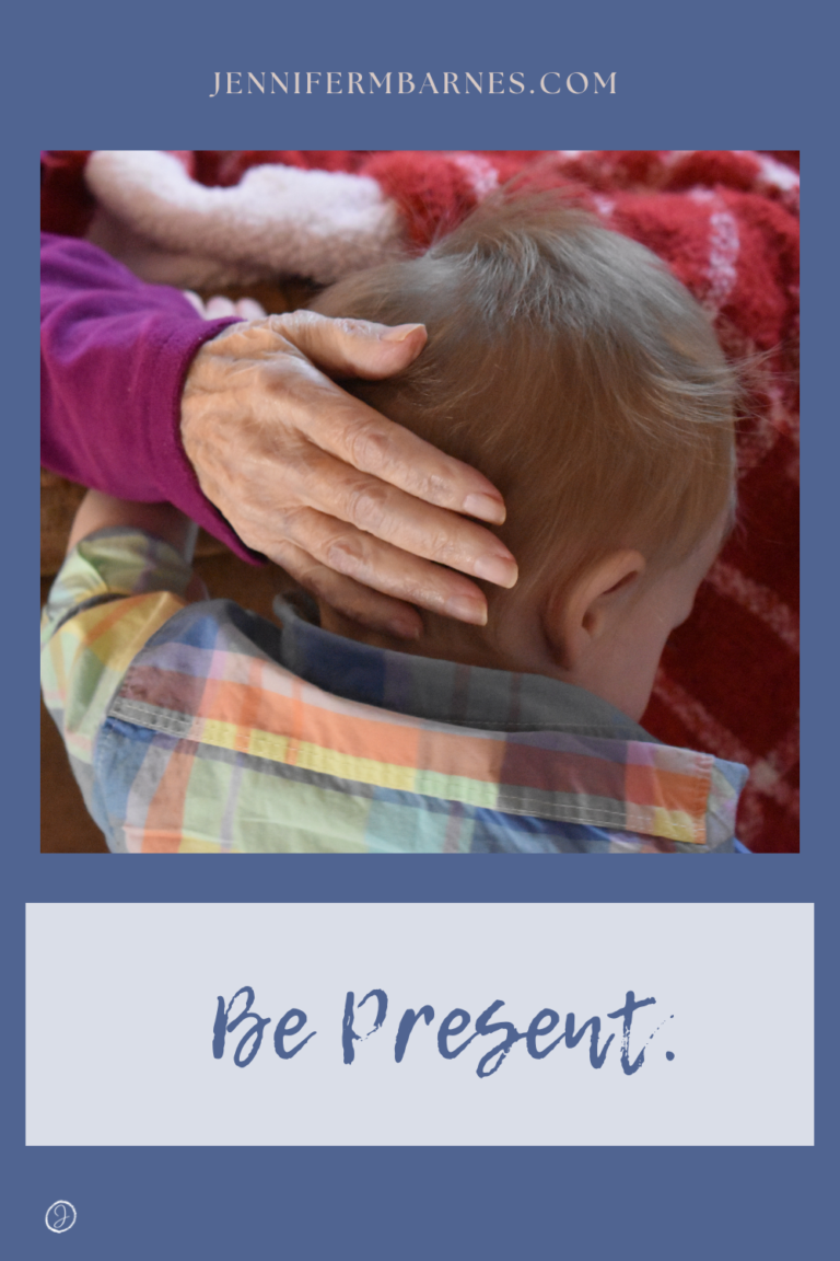 Image of a grandmother's hand patting the back of a baby's head with the caption, "Be present."."
